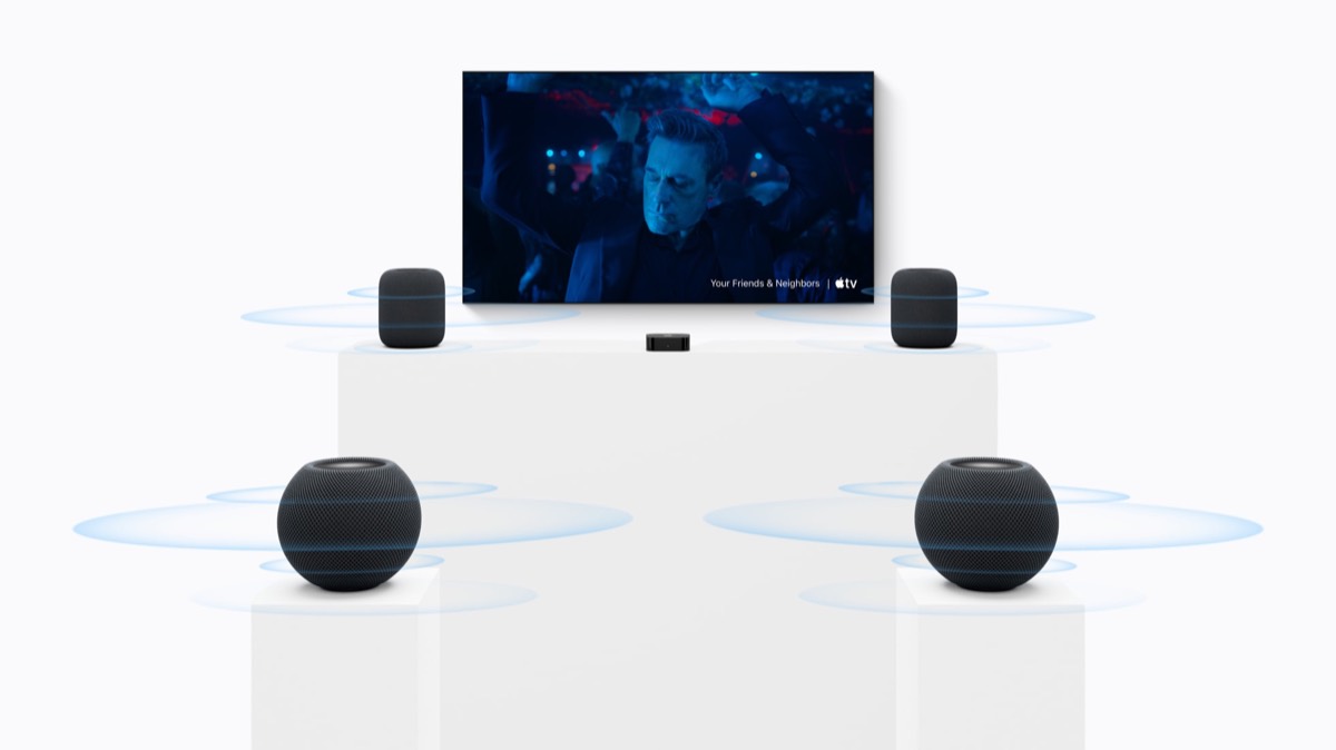 A living room home theatre with two HomePod (2nd generation) speakers either side of a television in front and two HomePod mini 2 speakers at the back of the room.